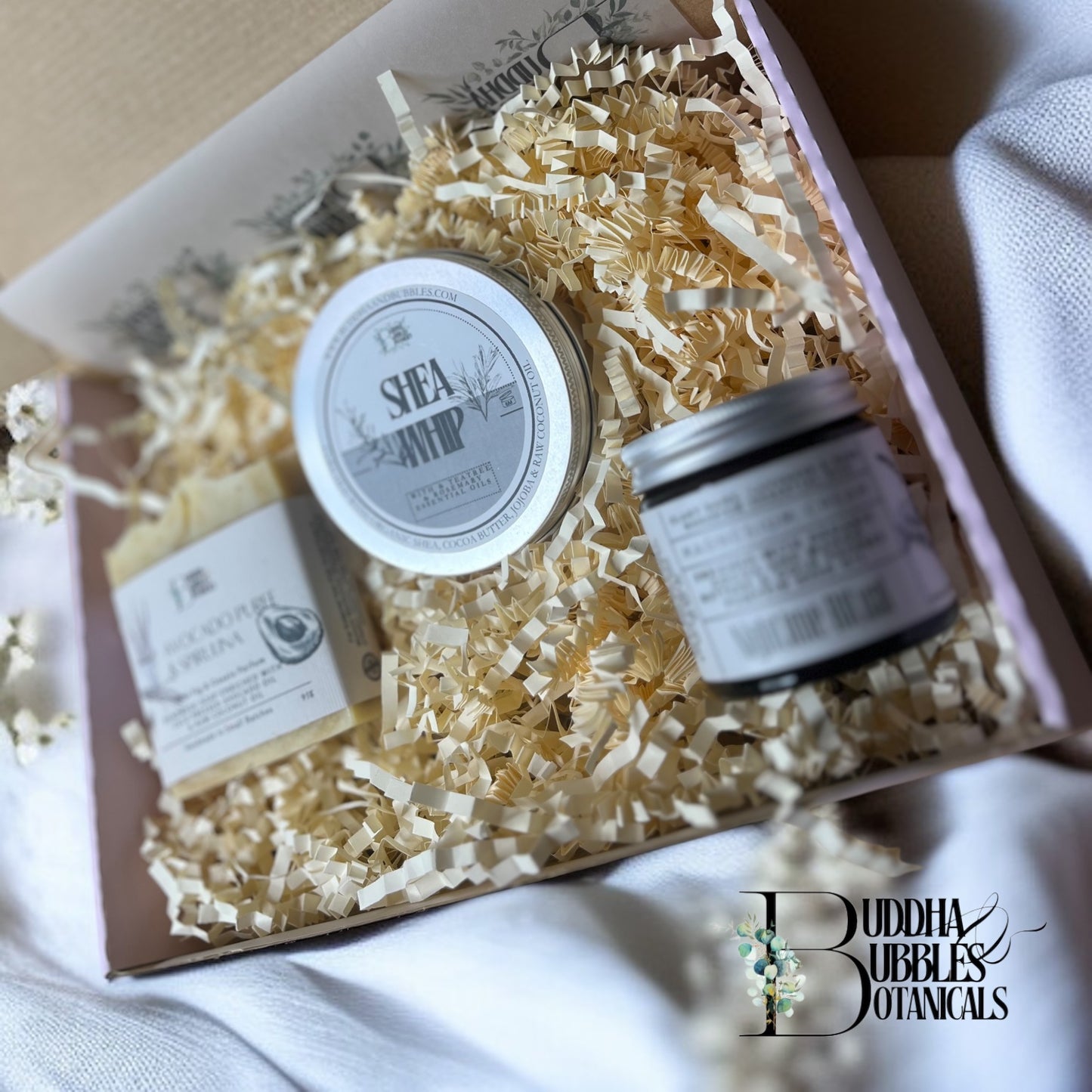 Xmas Gift Box of Buddha Bubbles Botanicals products including a magnesium cream jar, a large bar of soap, and a tin of shea whip body butter made by buddha and bubbles botanicals