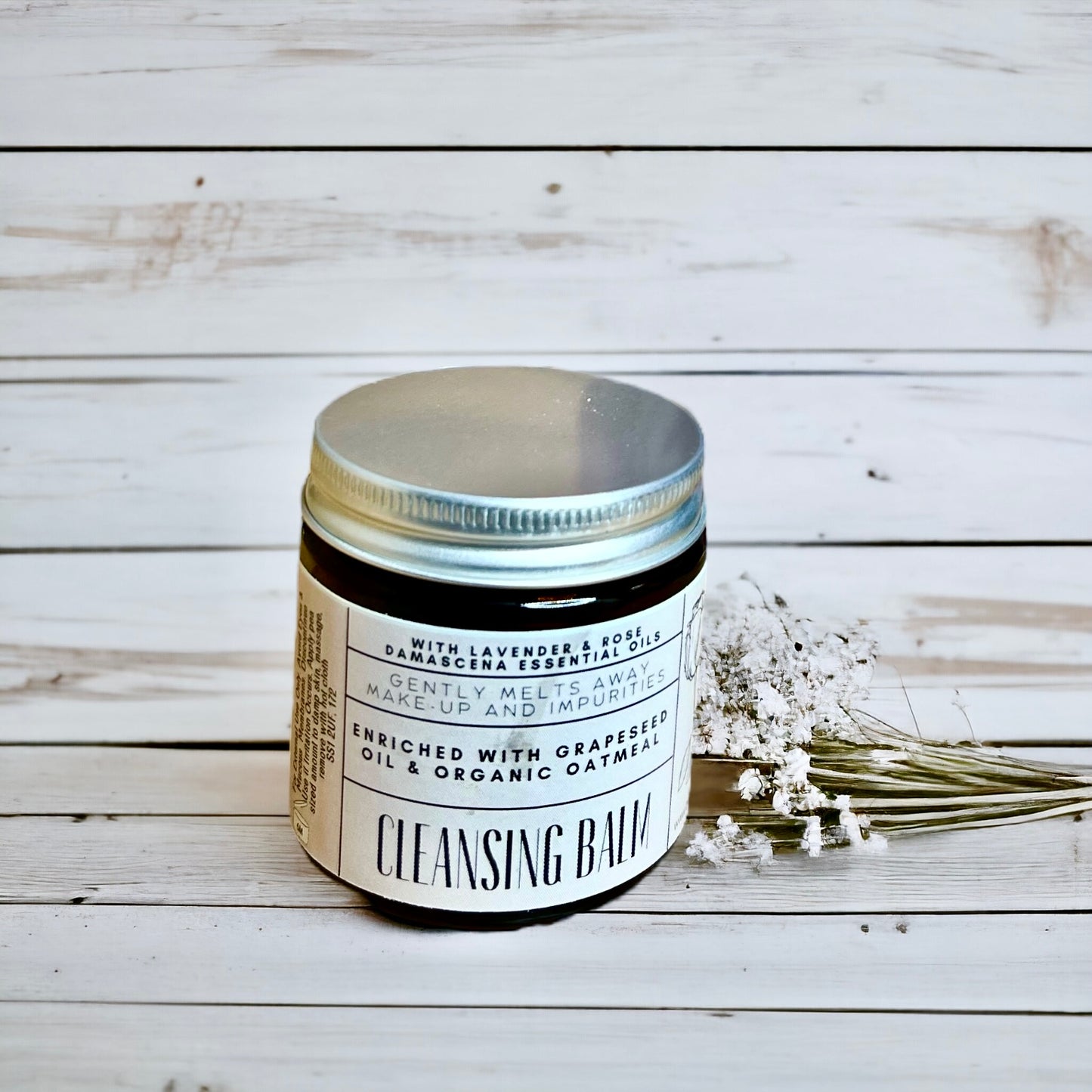 Cleansing balm jar with label on a wooden surface made by buddha and bubbles botanicals