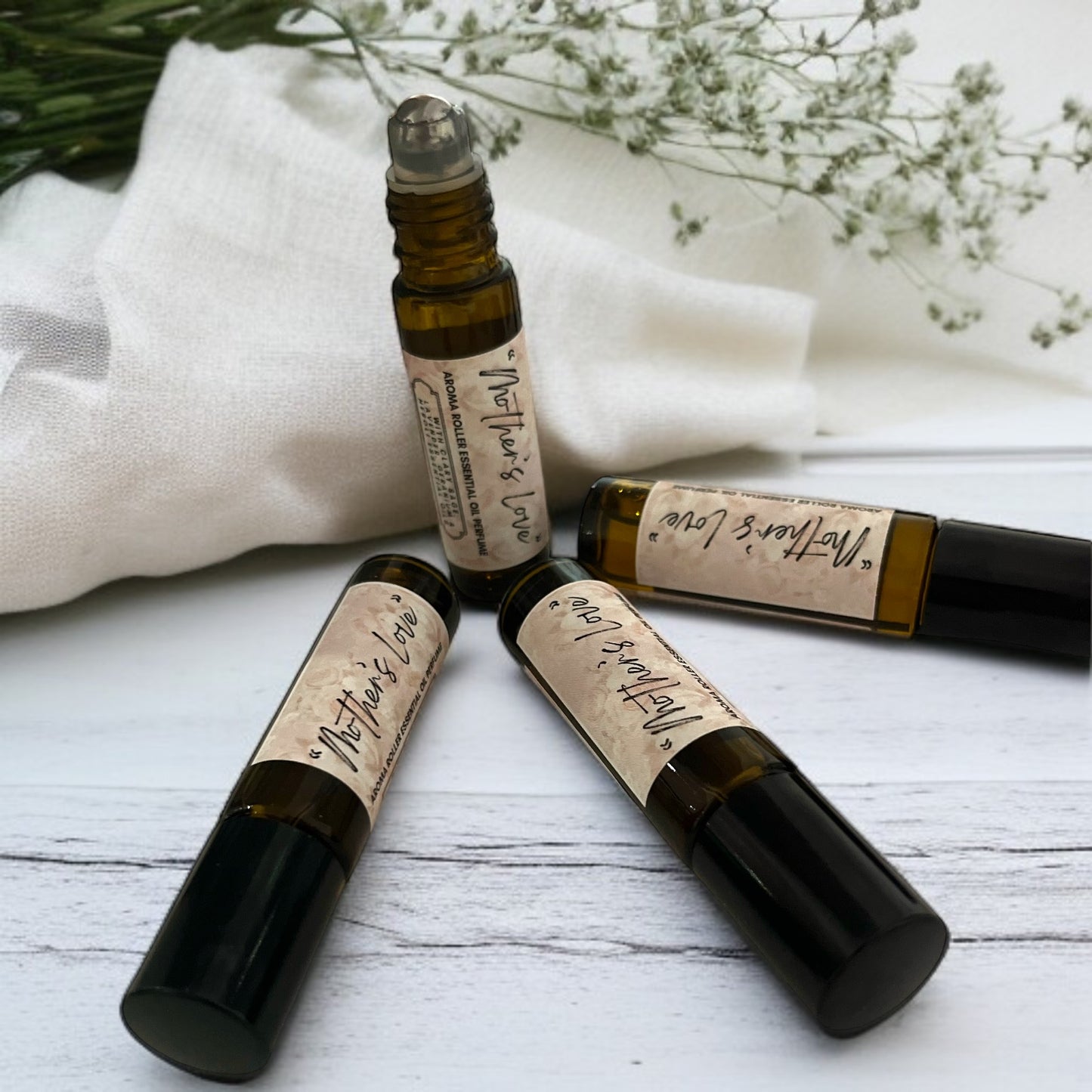 four pulse point aromatherapy amber glass roll on perfume bottles on white table made by buddha and bubbles botanicals