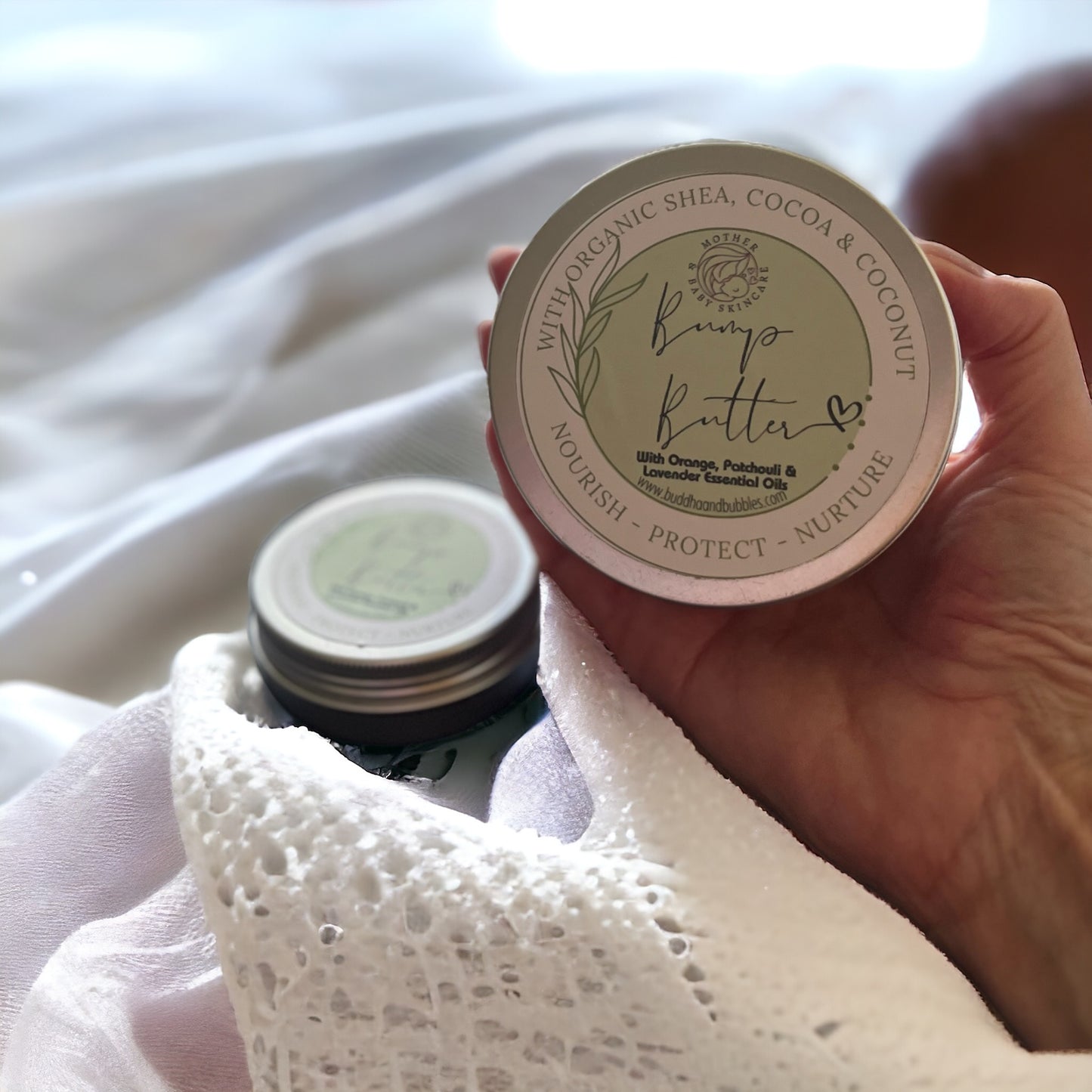 hand holding Pregnancy Bump butter with organic mango and Babassu butter with essential oils