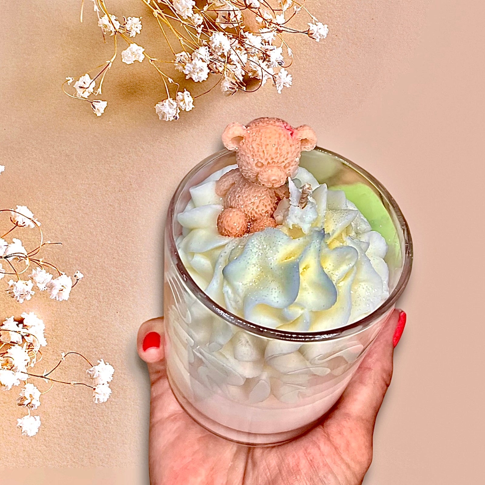 featuring a hand holding a Lily Berries handmade luxury whipped wax dessert candle with teddy bear