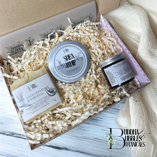 Xmas Gift Box of Buddha Bubbles Botanicals products including a magnesium cream jar, a large bar of soap, and a tin of shea whip body butter made by buddha and bubbles botanical