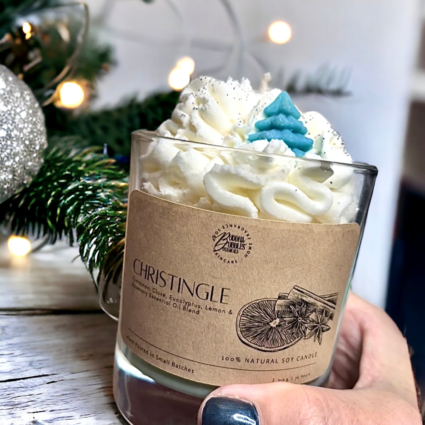 whipped soy Xmas candle with Christingje essential oils cedarwood, cypress, clove, and nutmeg essential oils, topped with a decorative whipped wax swirl in a clear glass jar. Perfect Xmas gift 