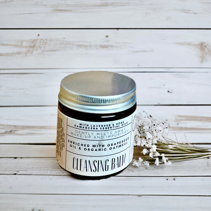 Cleansing balm jar with label on a wooden surface made by buddha and bubbles botanicals 