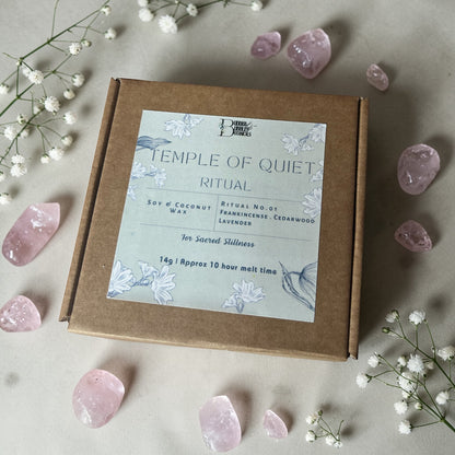 Box of 'Temple of Quiet' essential oil wax melts with pink crystals and flowers on a light background