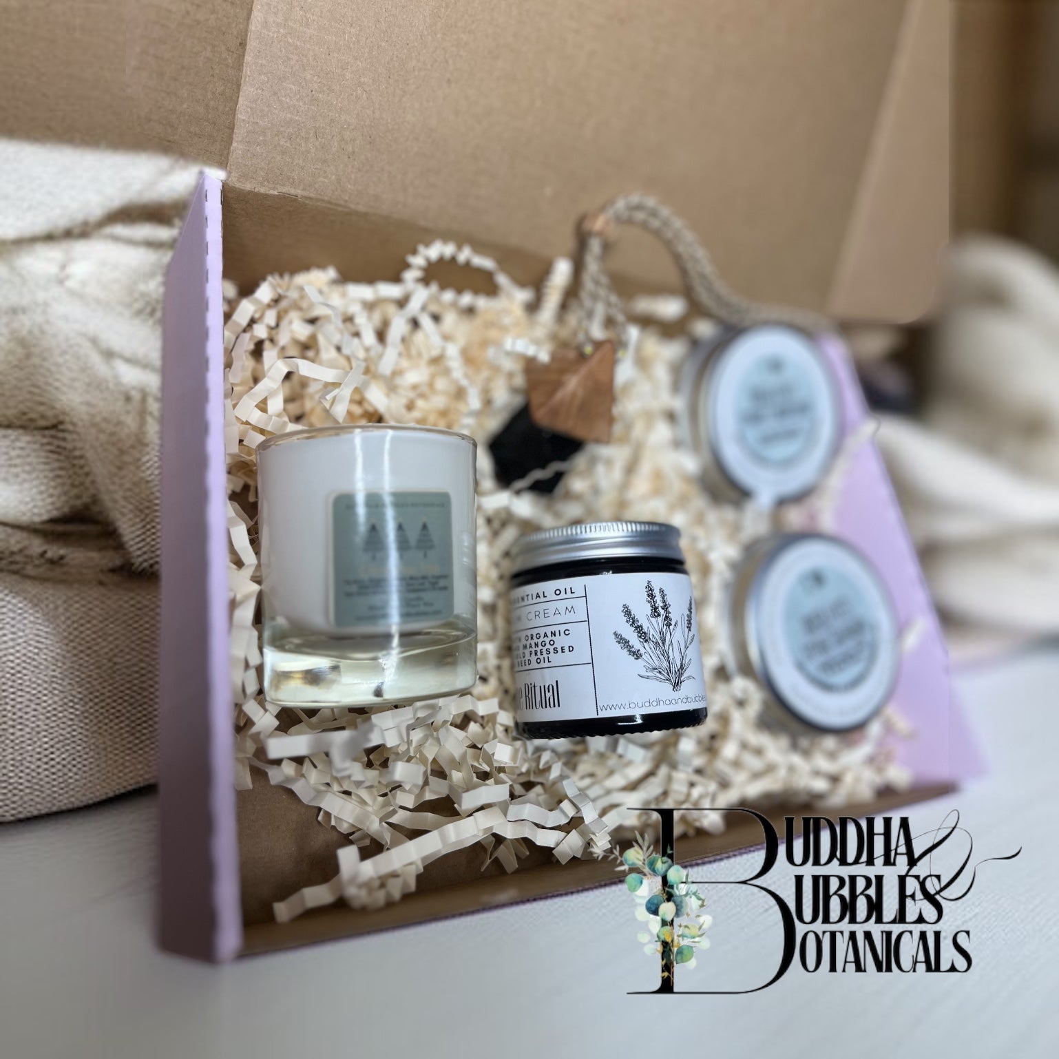 Gift set with candles and  beauty and haircare products in a decorative box, featuring Buddha Bubbles Botanicals branding.