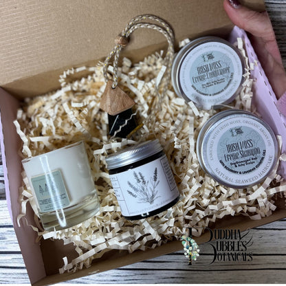 Xmas Gift set with candle seaweed shampoo and conditioner with magnesium cream  in a box labeled 'Buddha Bubbles Botanicals'.