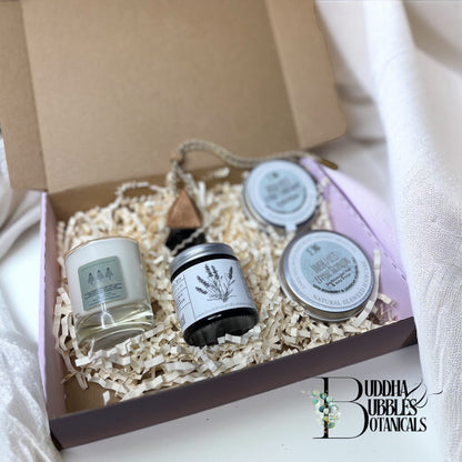 Candle in a jar in a box with magnesium cream, car air freshener and seaweed shampoo and conditioner 'Buddha Bubbles Botanicals' branding.