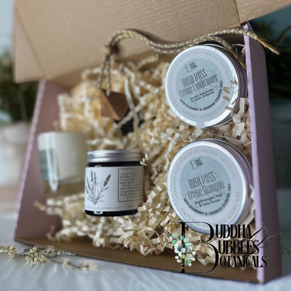 Buddha Bubbles Botanicals beauty and  hair care products in a gift box with decorative elements.