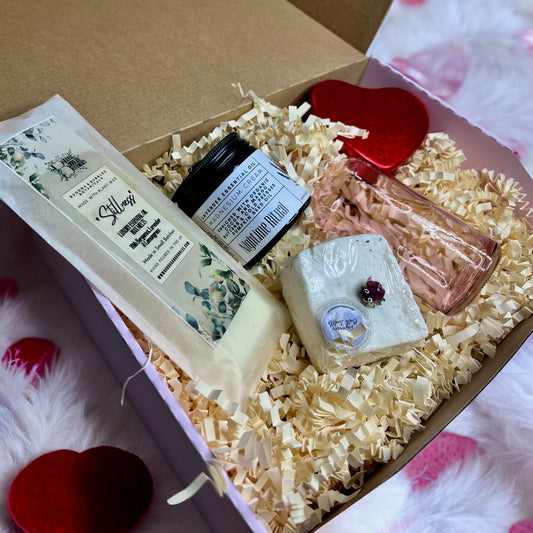 Gift box with skincare products including wax melts, bath truffle, magnesium cream, bath elixir and candle