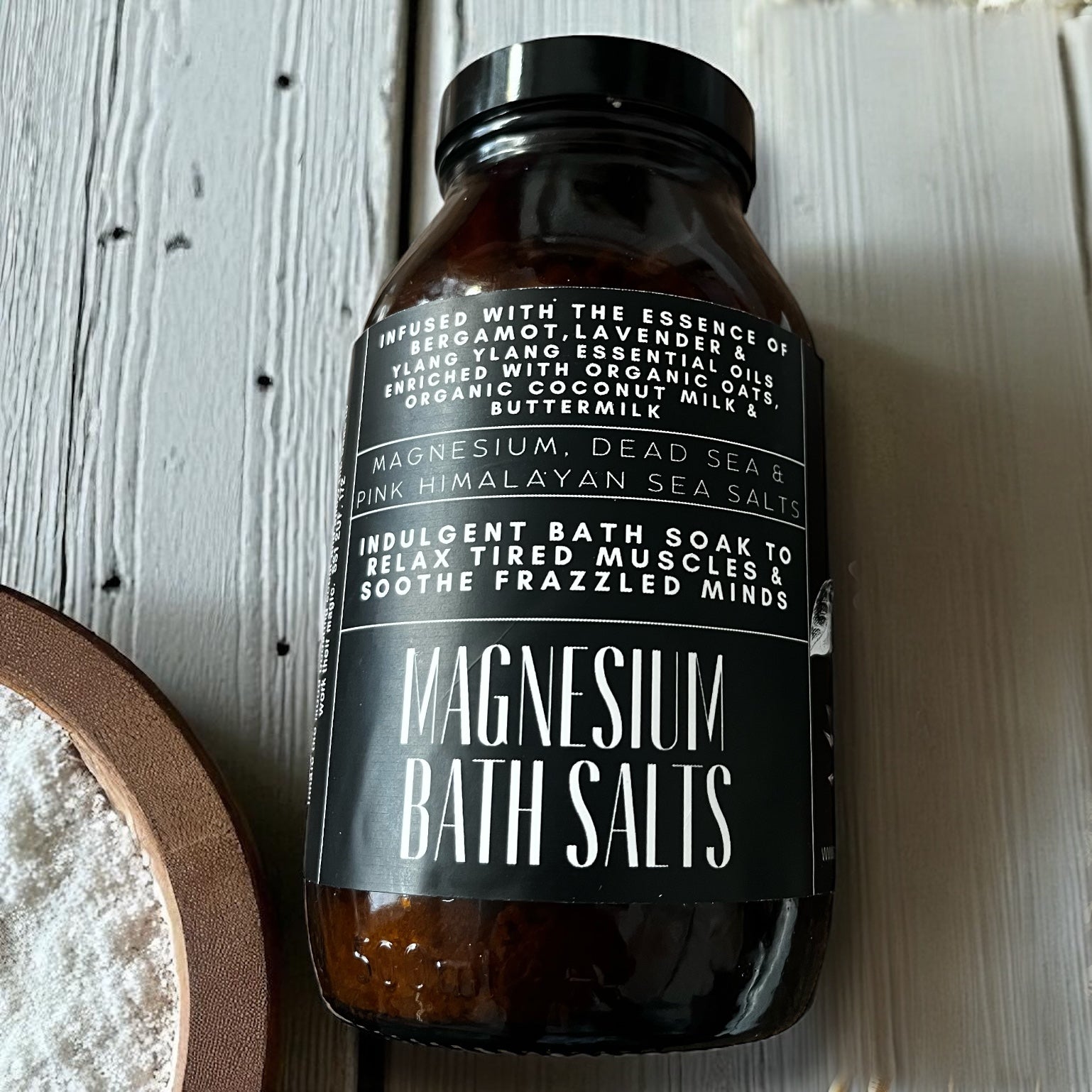 Bottle of magnesium bath salts with a label on a wooden surface