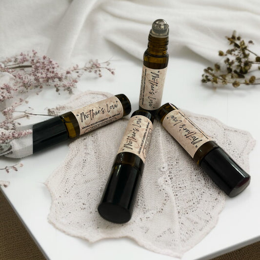 three pulse point aromatherapy amber glass roll on perfume bottles on white table made by buddha and bubbles botanicals