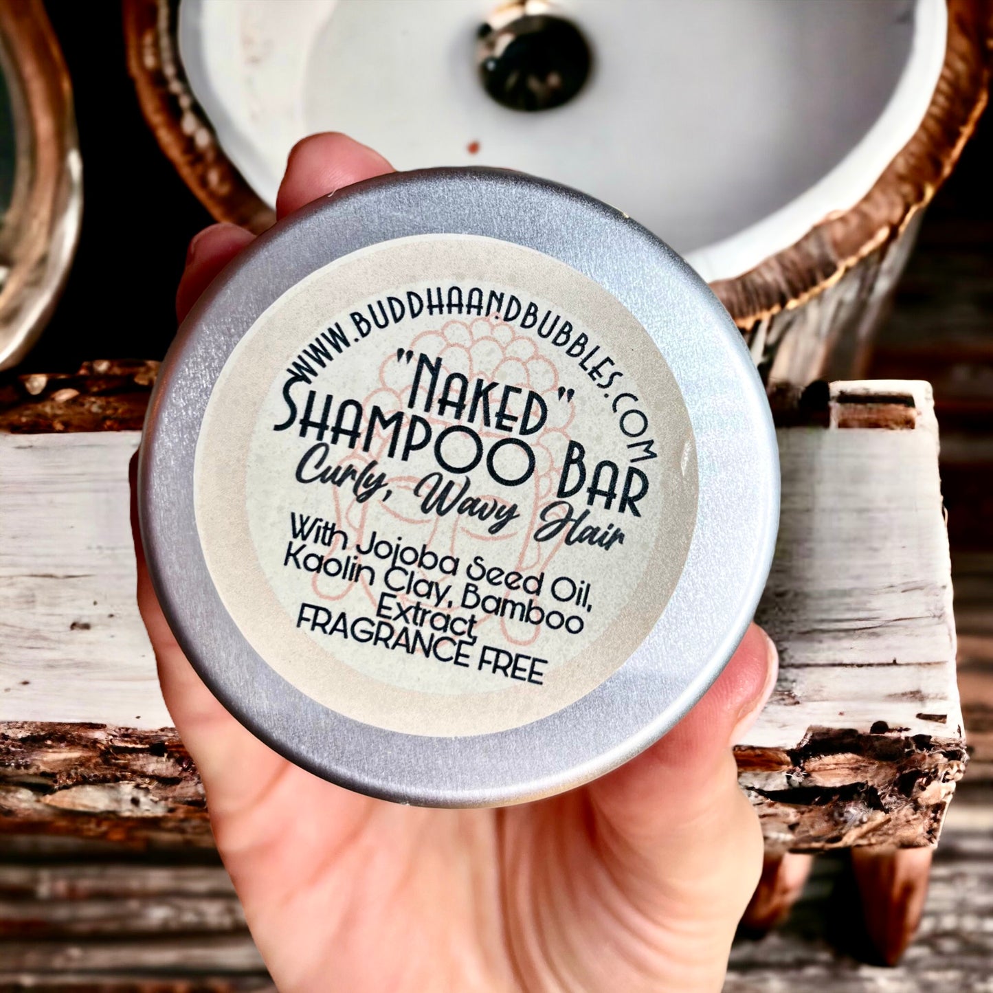 featuring a hand holding a NAKED Solid shampoo and Conditioner bar - Buddha and Bubbles Botanicals