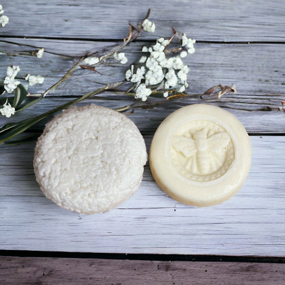Shampoo and Conditioner Bar on a wooden surface with decorative flowers.