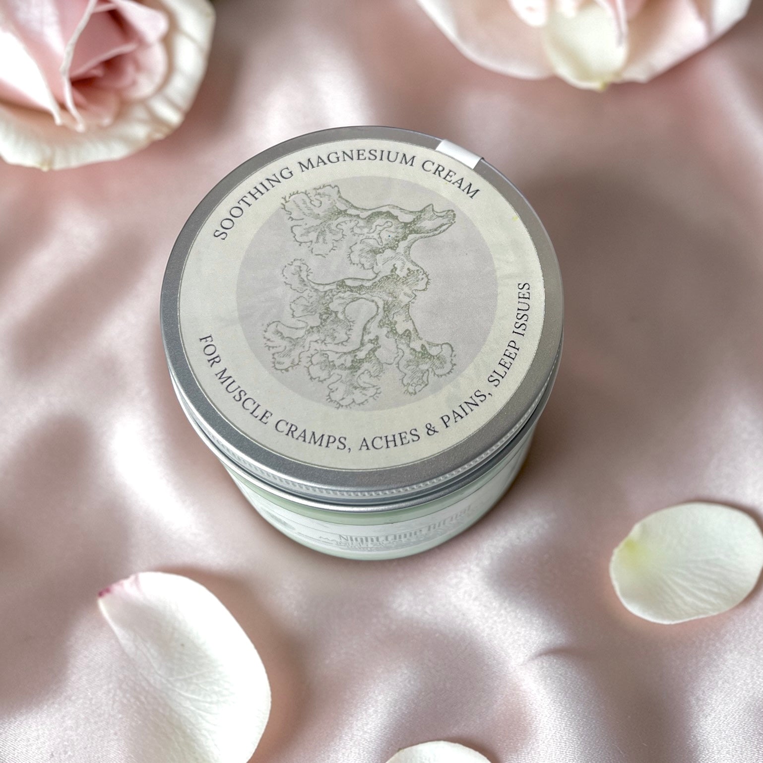 jumbo Jar of soothing magnesium cream on a pink satin background with flowers
