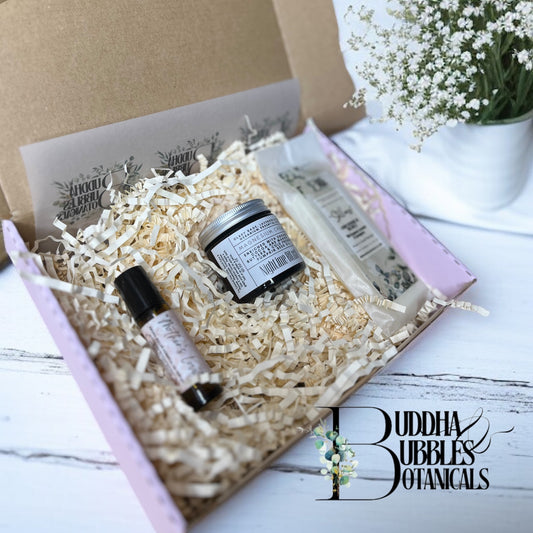 xmas pamper box with pulse point rollerball magnesium cream and wax melts on a white shelf 