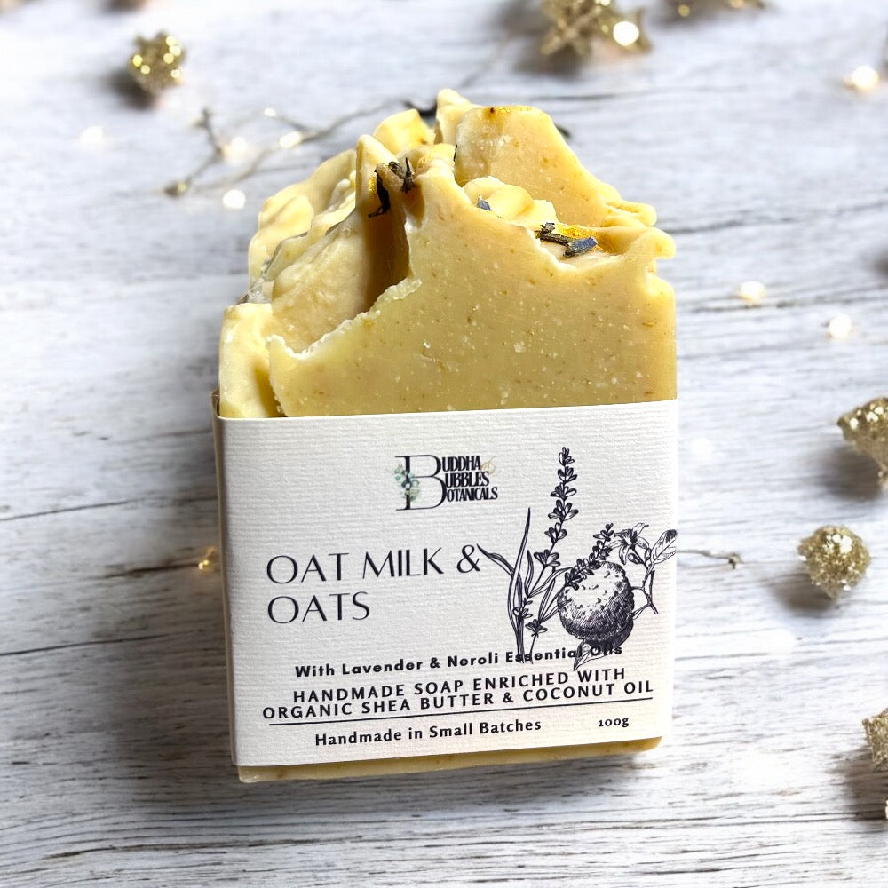 Soap bar with oat milk and oats with lavender and neroli essential oils on white wooden table