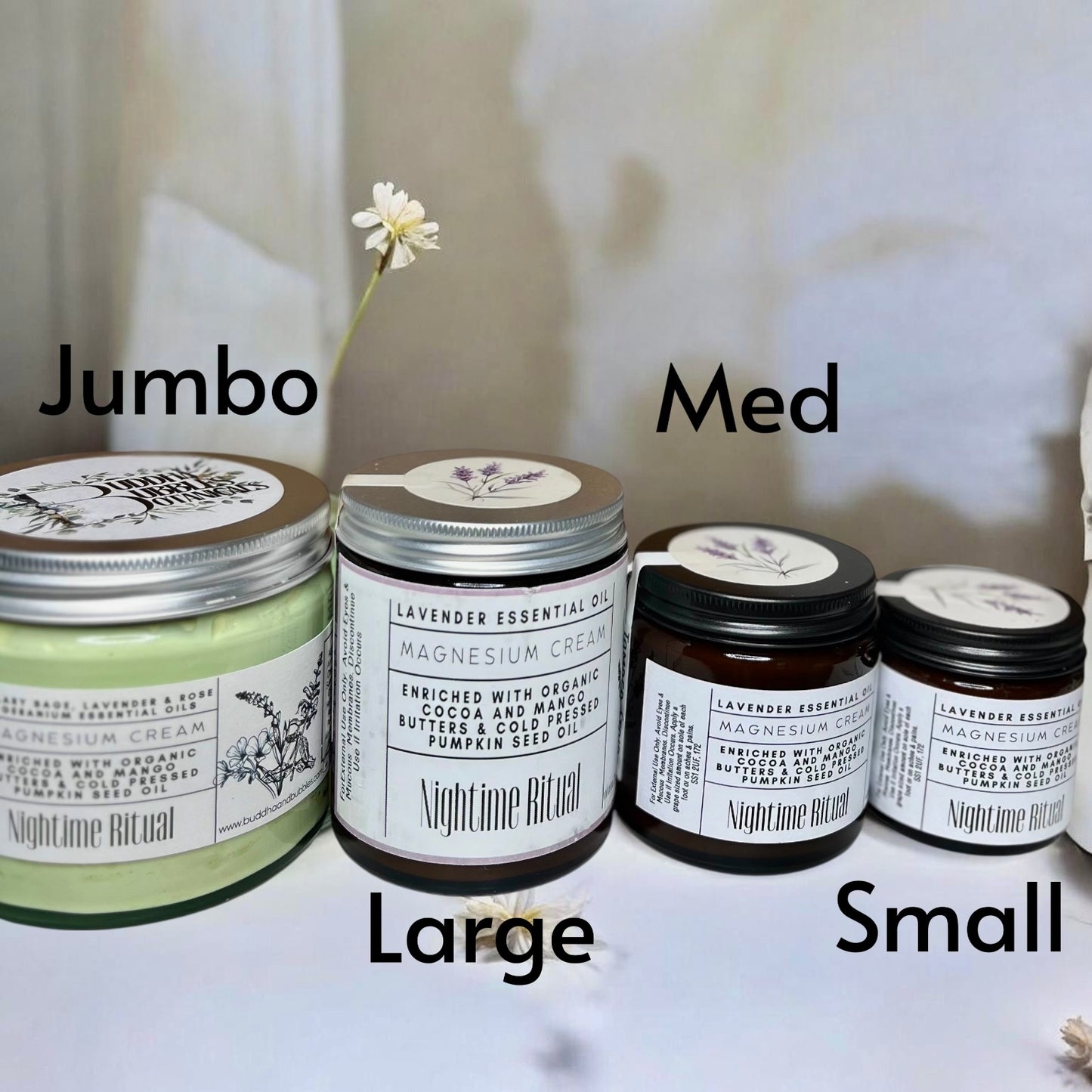 Four jars of magnesium cream showing different sizes labelled 'Jumbo', 'Med', 'Large', and 'Small' on a white surface.