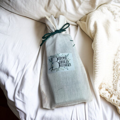 Buddha Bubbles Botanicals snap bar wax melt in a drawstring bag on a white surface sustainable wax melt gift