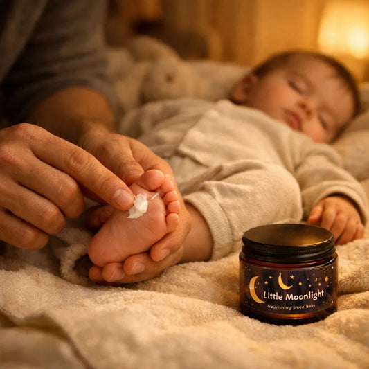 Person applying cream to a child's foot with 'Little Moonlight' cream in the foreground.