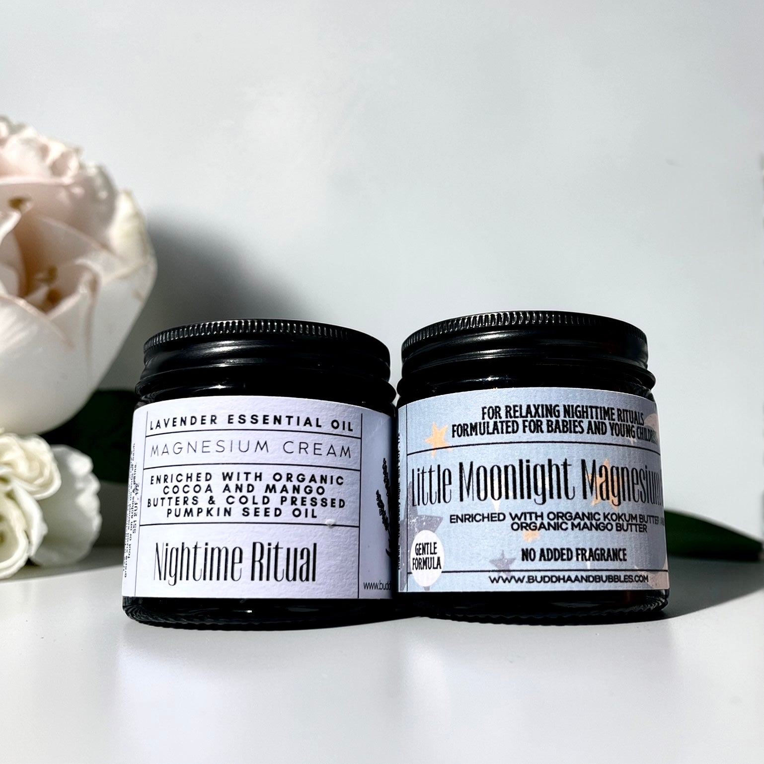 Two jars of magnesium cream with labels on a white background