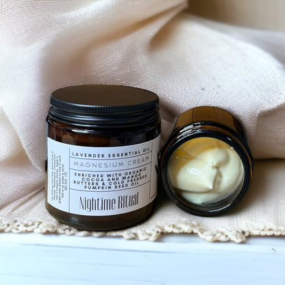 Close-up photo of Buddha and Bubbles Botanicals natural restless legs magnesium cream with open jar showing the texture. 