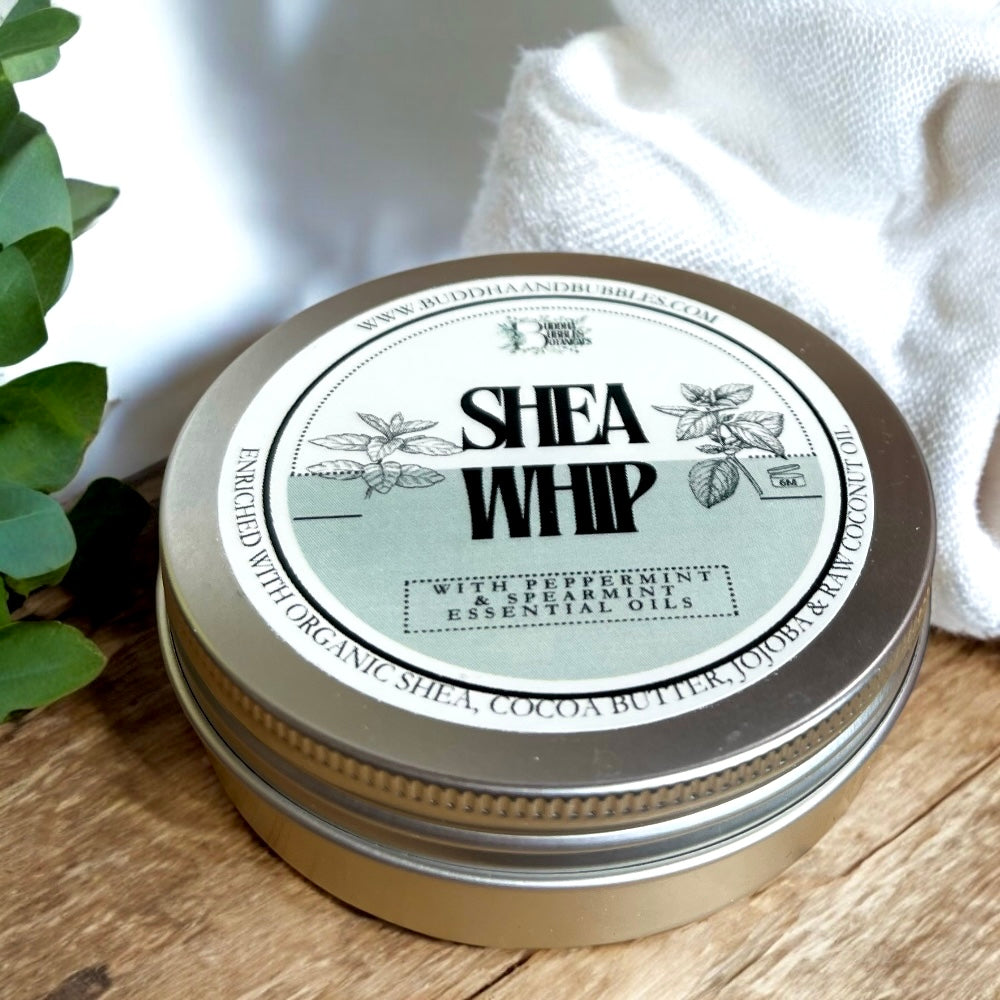 a tin of handmade shea whip body butter with peppermint and spearmint essential oils on a wooden table made by buddha and bubbles botanicals