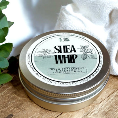 a tin of handmade shea whip body butter with peppermint and spearmint essential oils on a wooden table made by buddha and bubbles botanicals