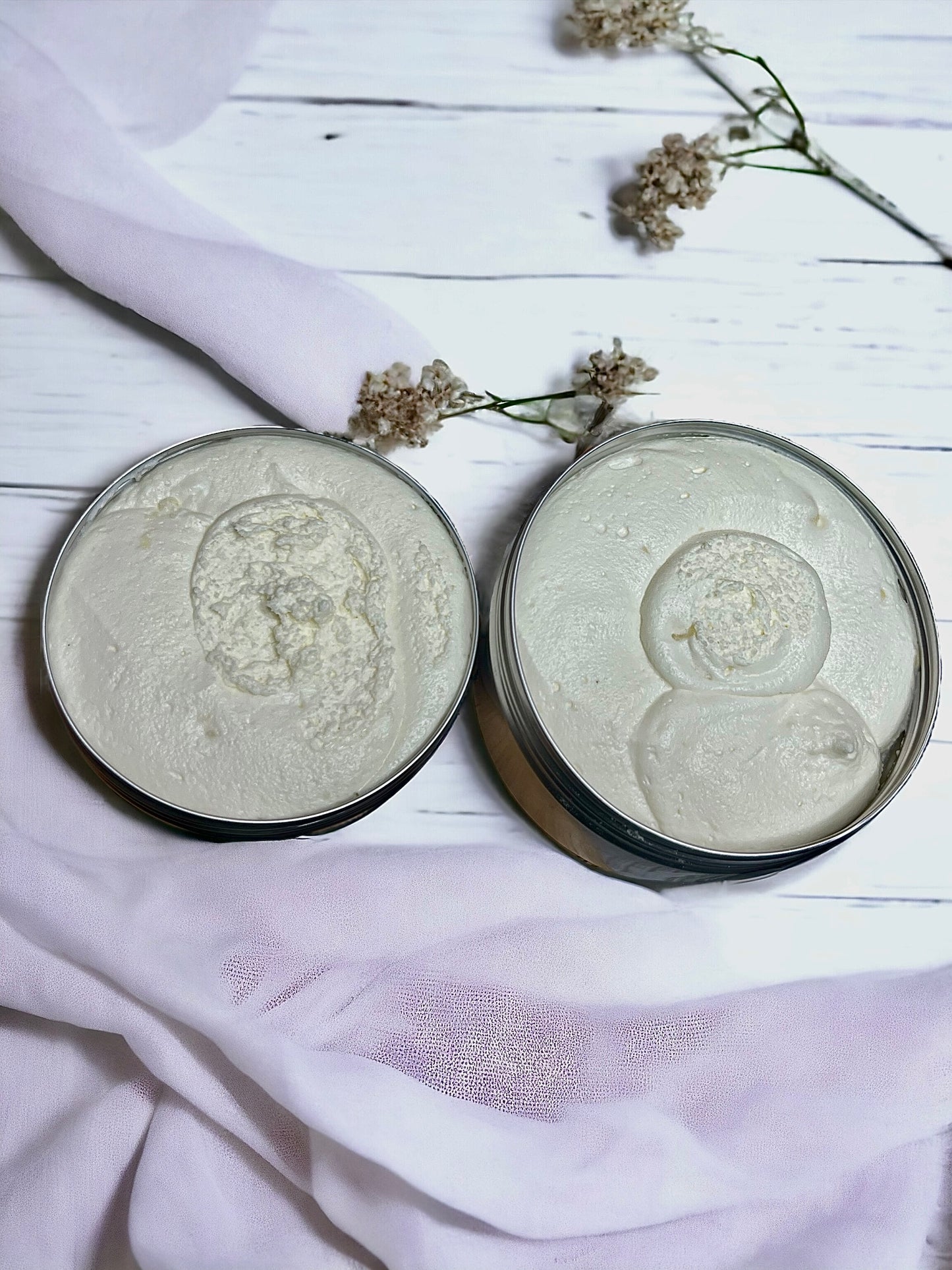showing the texture of the shea whip body butter with lids open on a white background