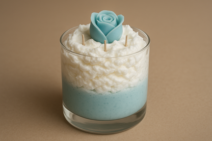 triple wicked whipped wax candle in glass jar with a light blue base and white whipped wax with a light blue rose bud wax melt embed on top